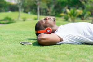 https://ivypanda.com/blog/wp-content/uploads/2021/03/serene-black-man-resting-park-listening-music.jpg